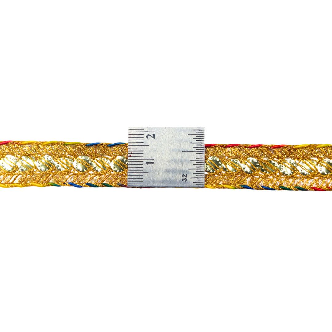 Gold braided belt with a ruler for scale on a white background