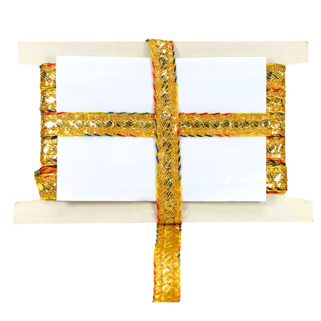 Decorative gold ribbon with a white card on a wooden stand against a white background