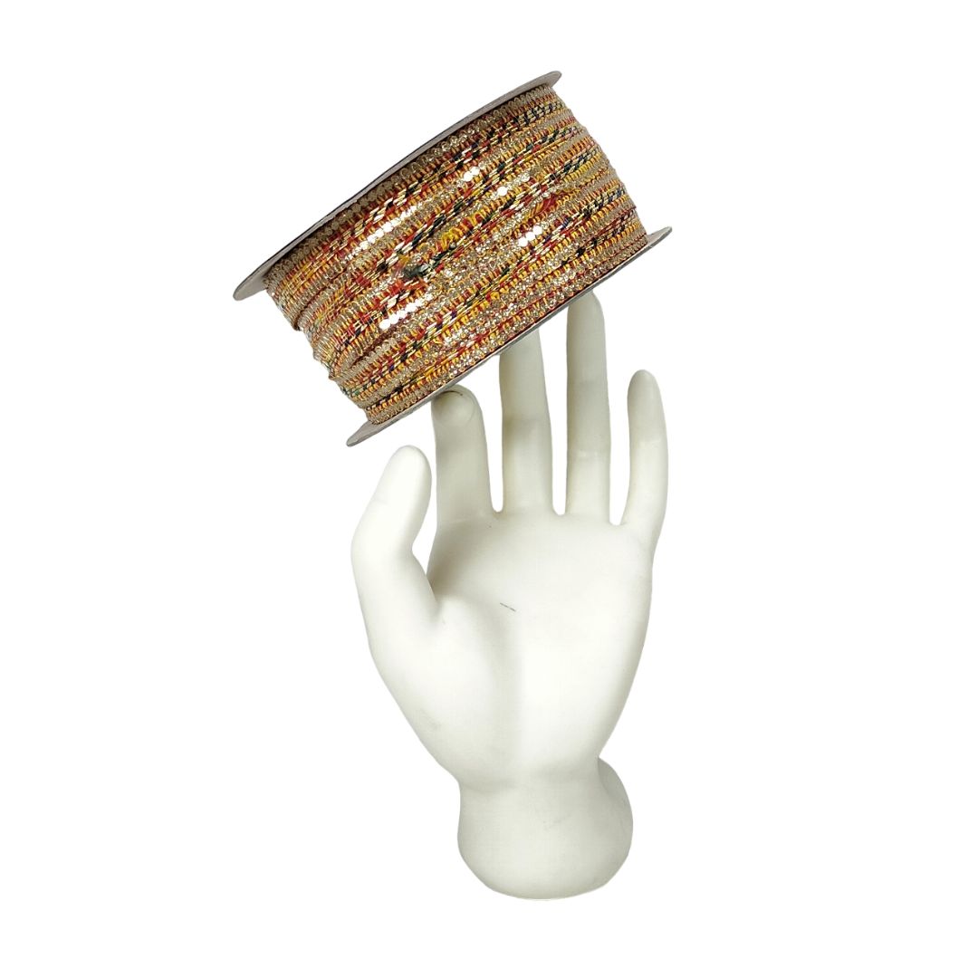 Spool of decorative ribbon on a white mannequin hand