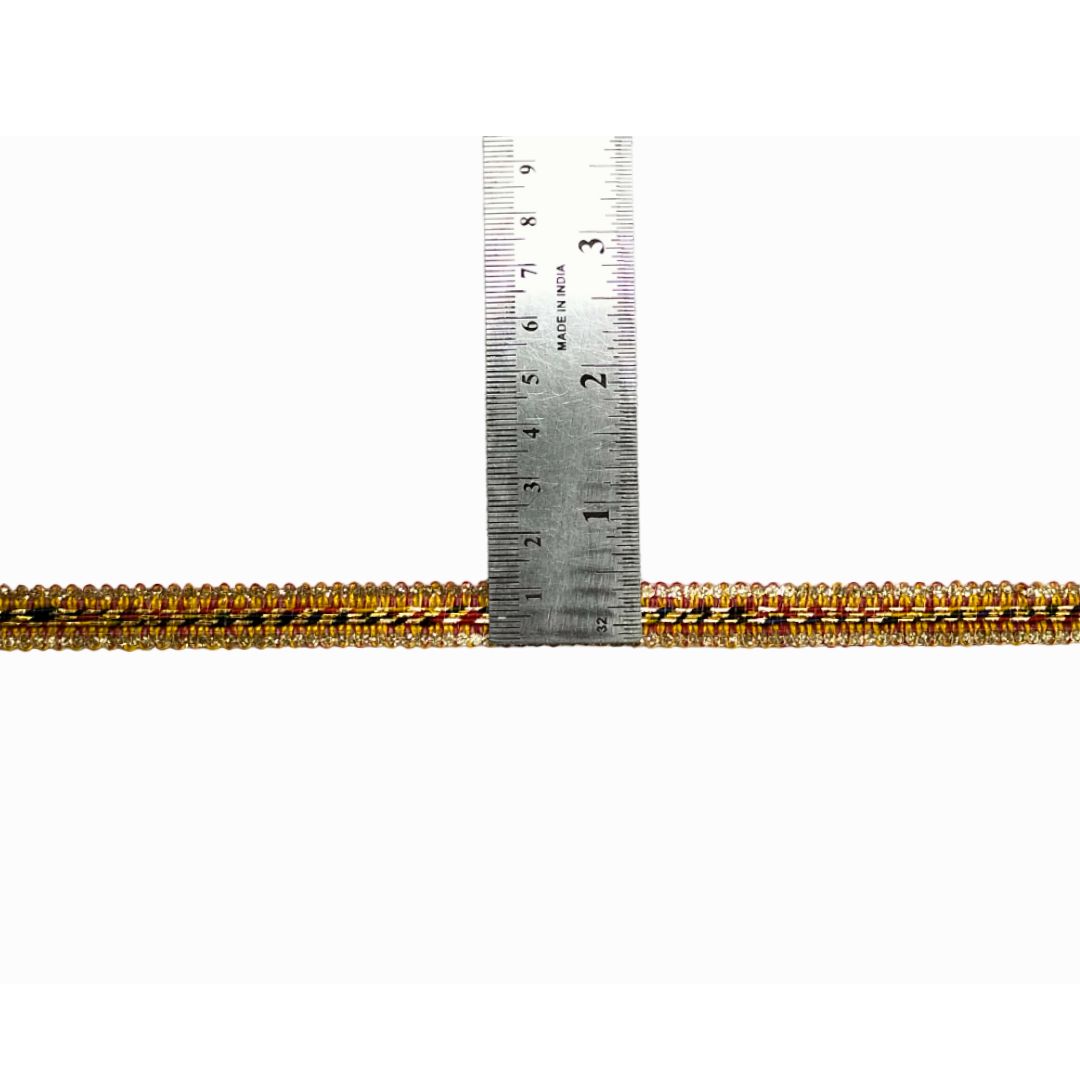 Gold and black beaded rope with a ruler for scale on a white background