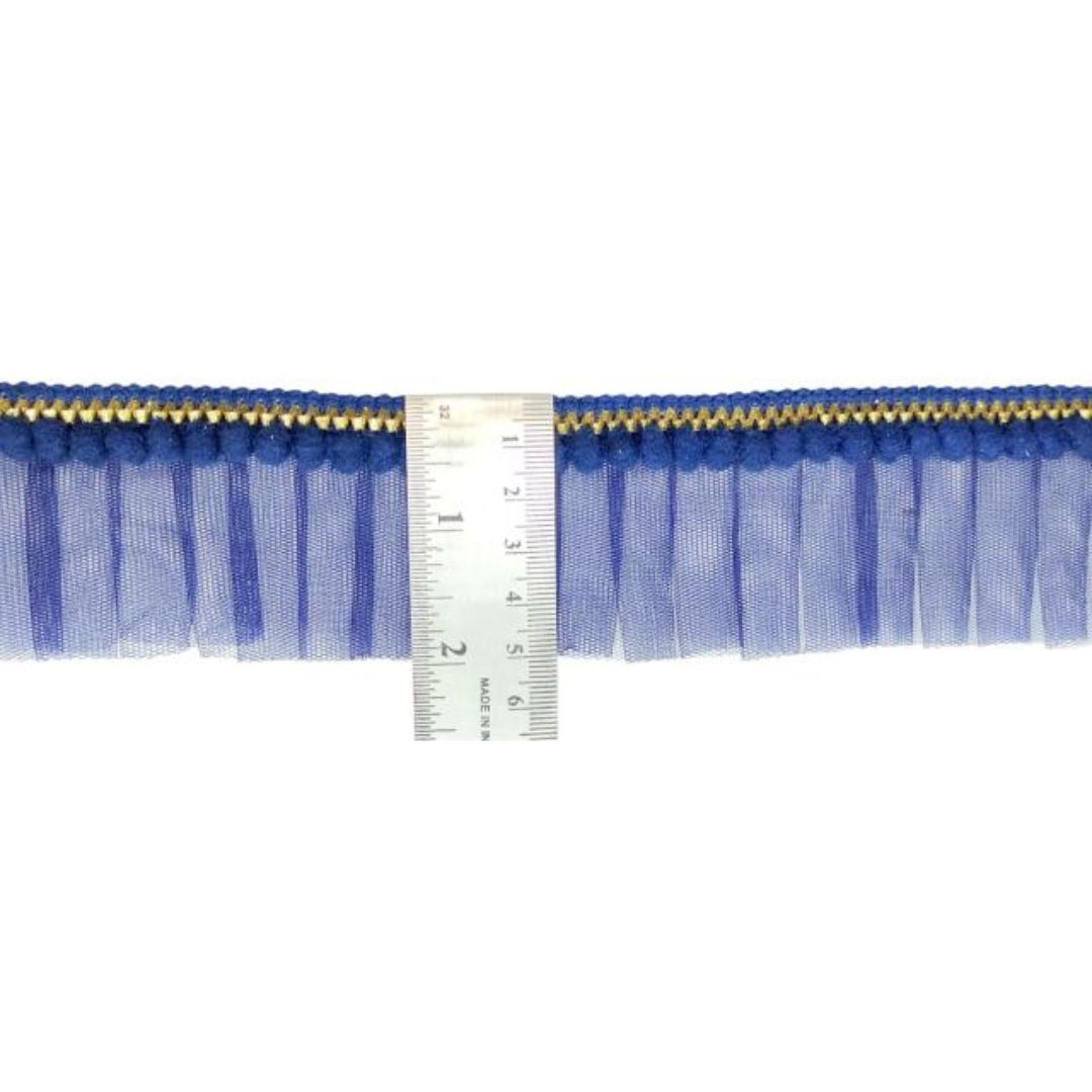 Blue fringe trim with a ruler for measurement on a white background