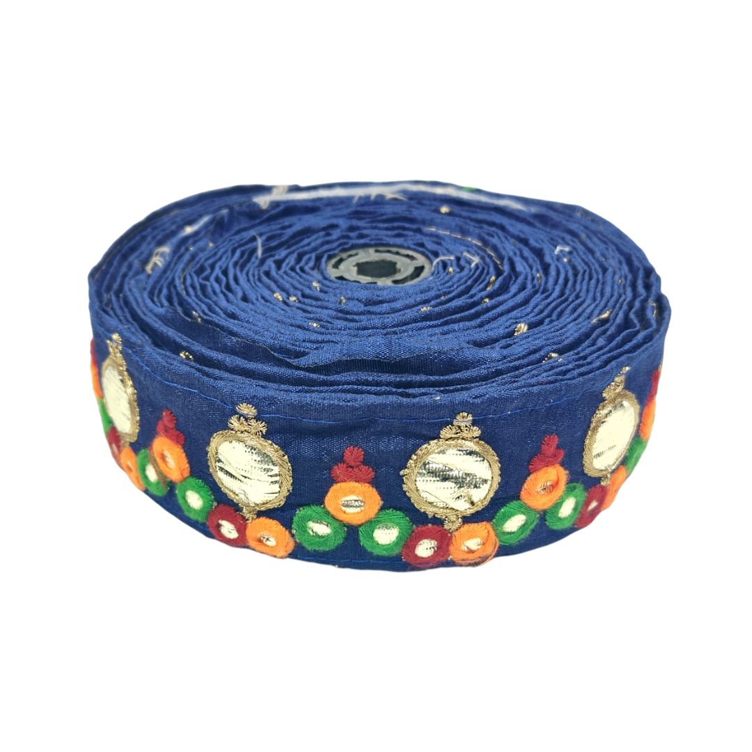 Roll of blue fabric with colorful decorative patterns on a white background