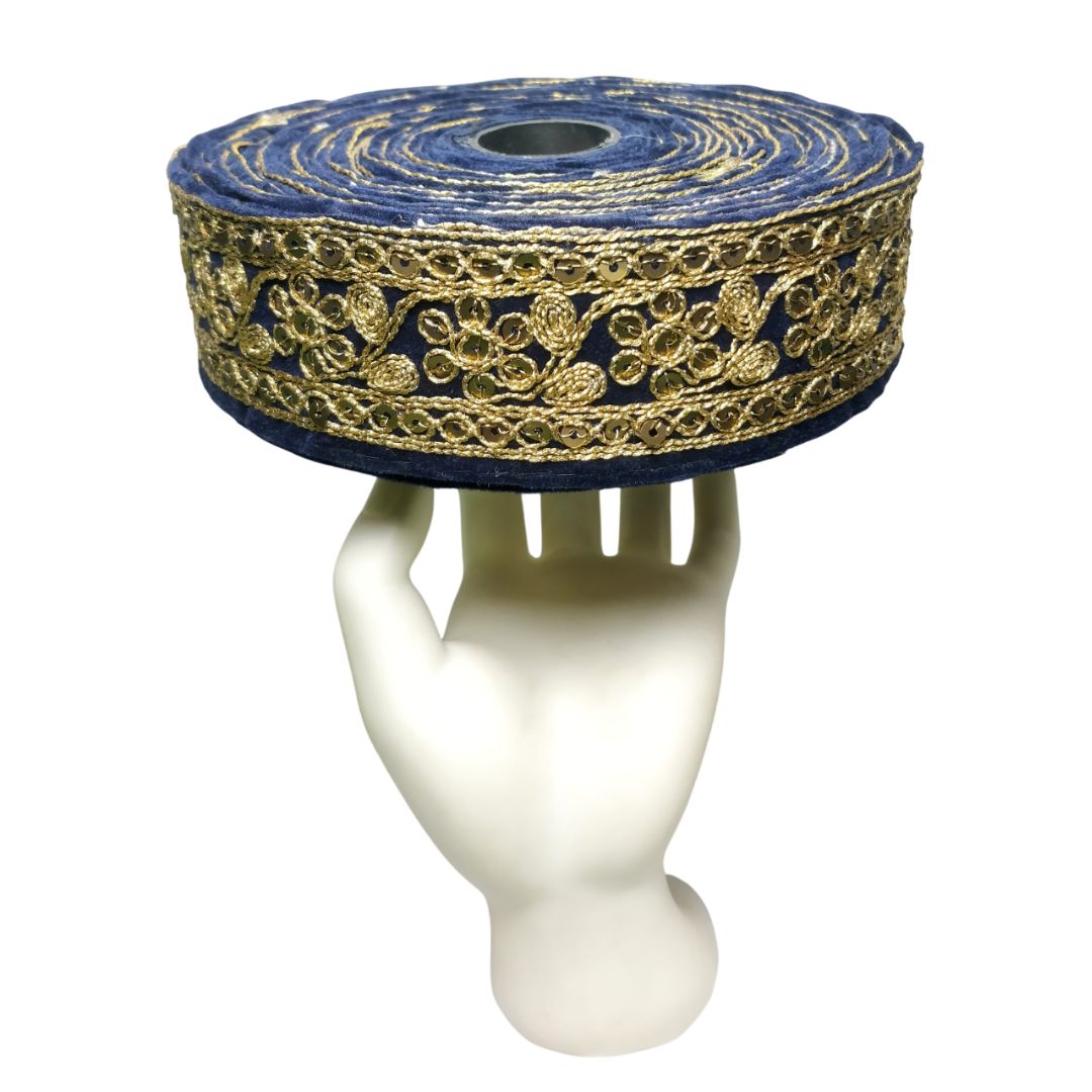 Roll of blue and gold decorative ribbon on a white mannequin stand.