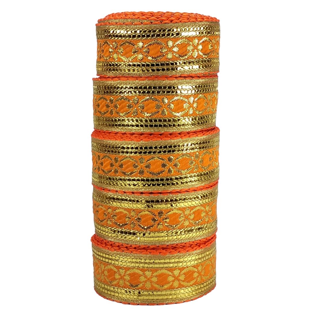Stack of gold and orange bangles on a white background