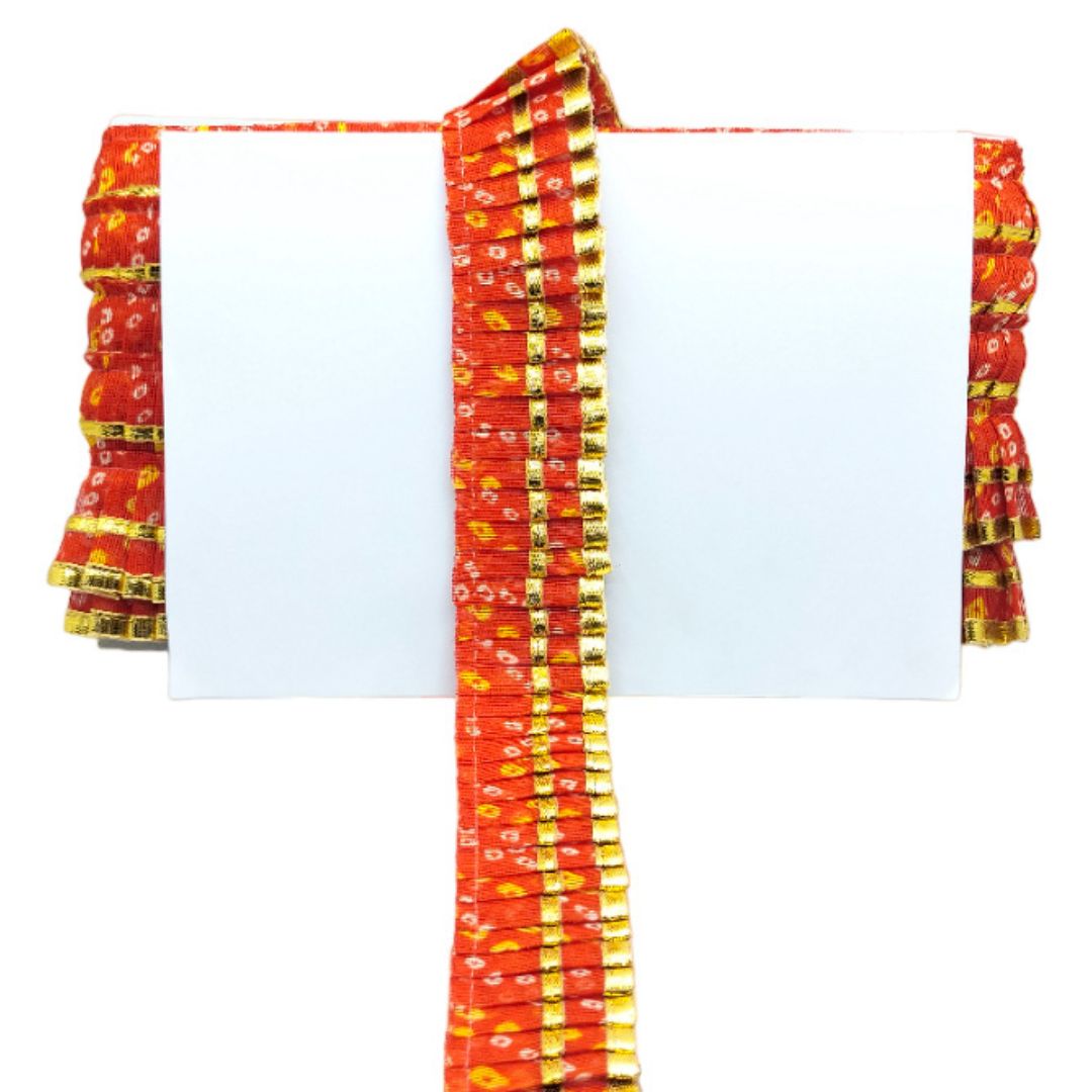 Red and yellow patterned fabric draped over a white background