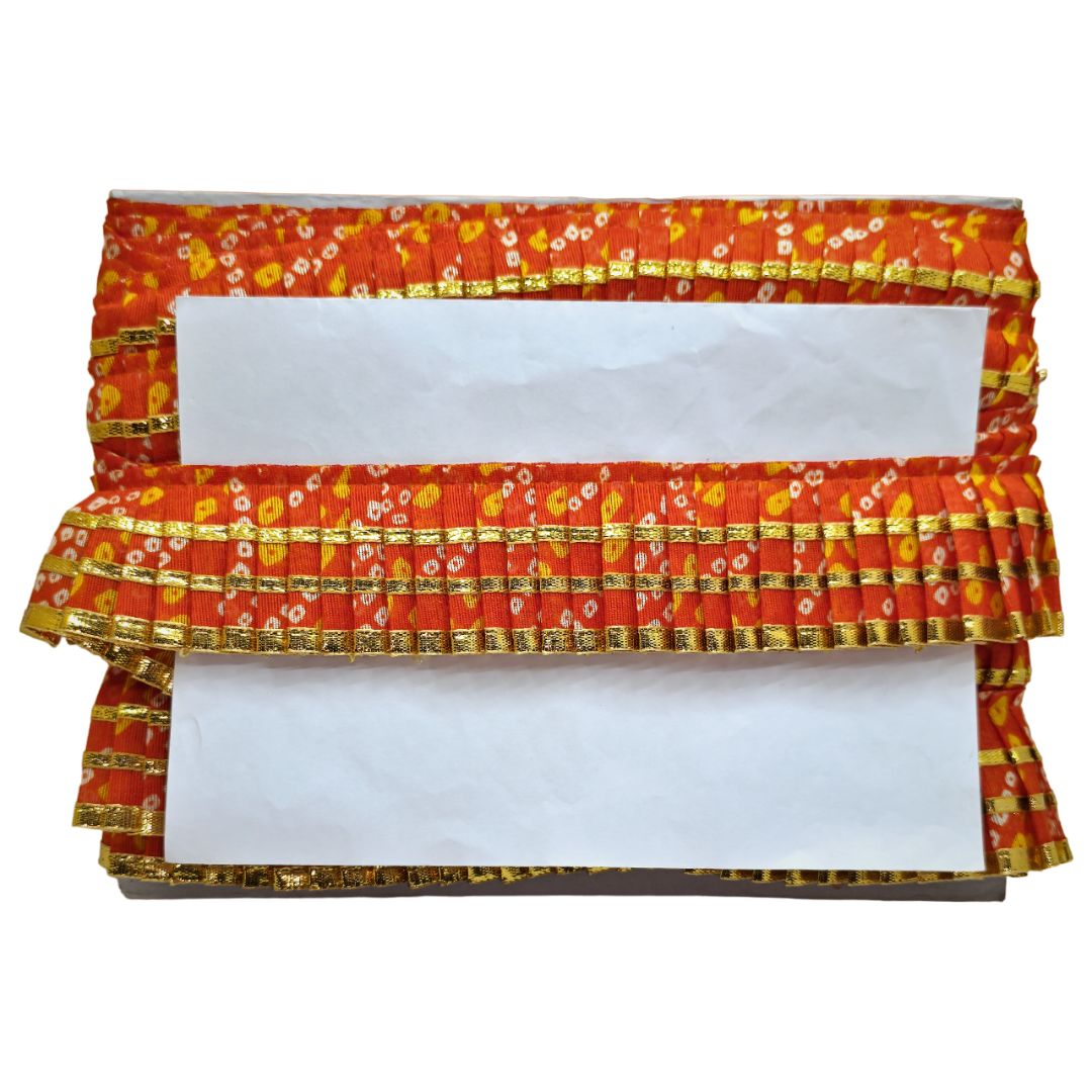 Decorative clutch with red, gold, and white pattern on a white background