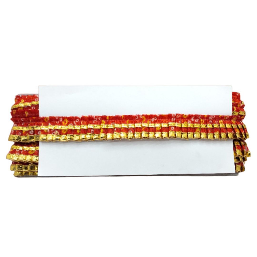 Clutch bag with red and gold beaded trim on a white background