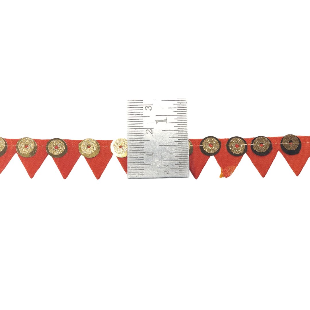 Red banner with gold circular designs and a ruler for scale on a white background