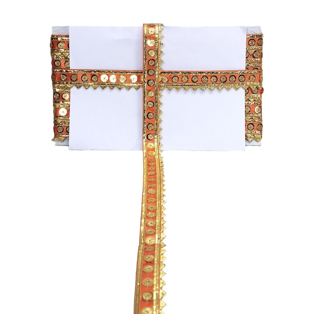 Decorative headpiece with gold and red embellishments on a white background