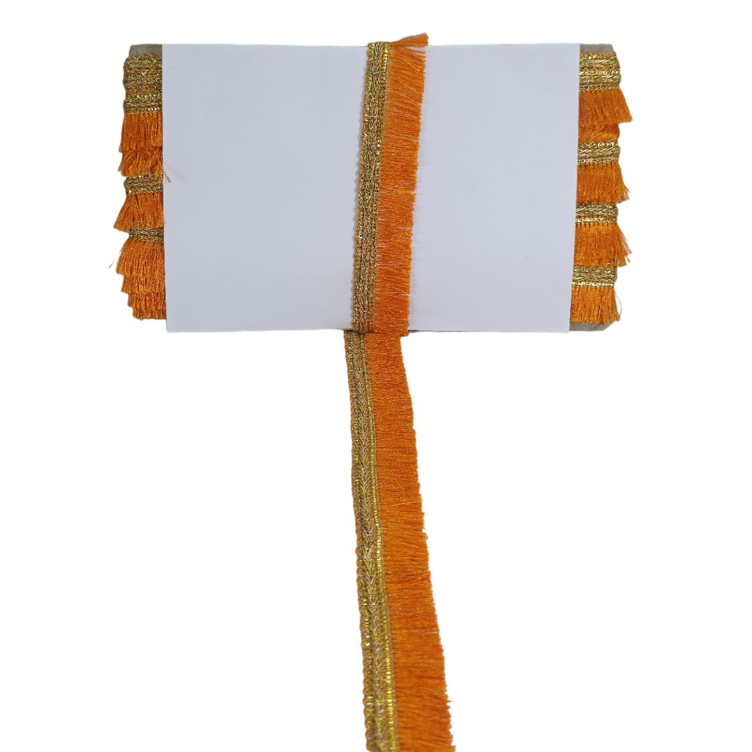 Decorative table runner with orange and gold fringe on a white background