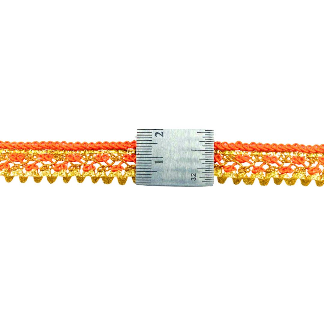 Close-up of orange and yellow lace trim with a ruler for scale on a white background