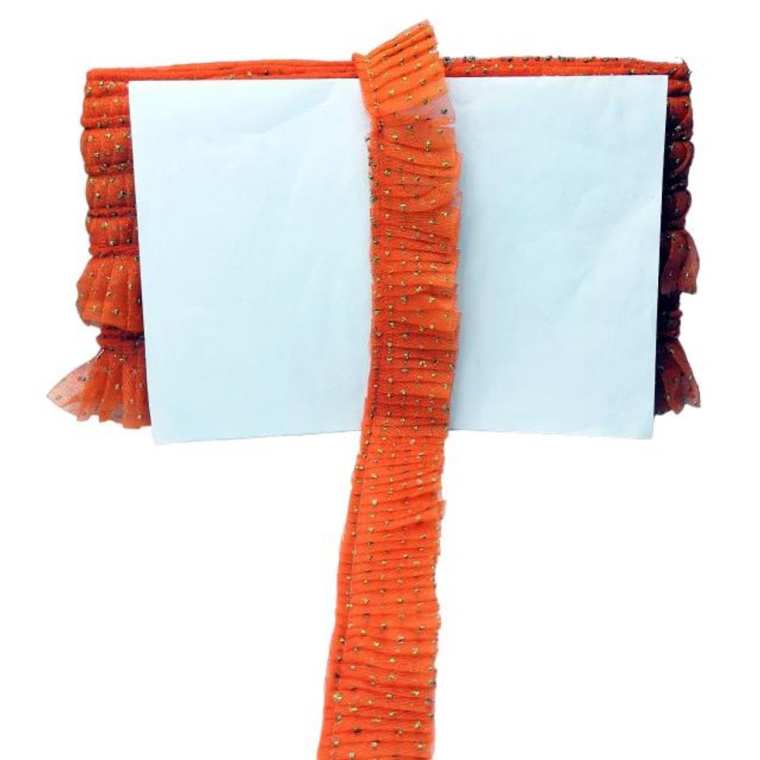 Decorative orange ribbon with tassels on a white background