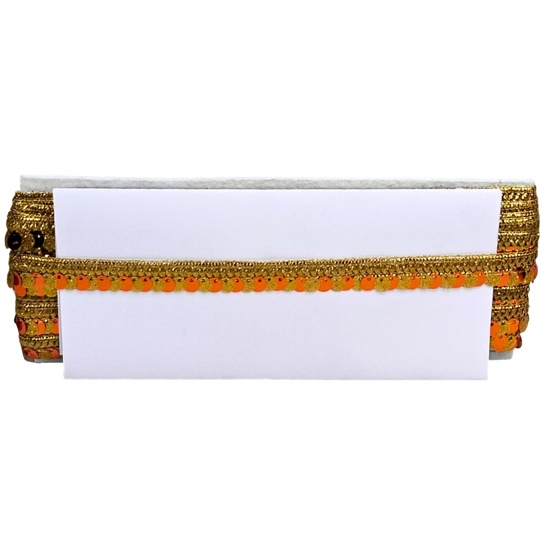 Decorative belt with gold and orange trim on a white background