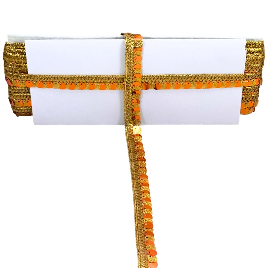 Decorative belt with gold and orange pattern on a white background