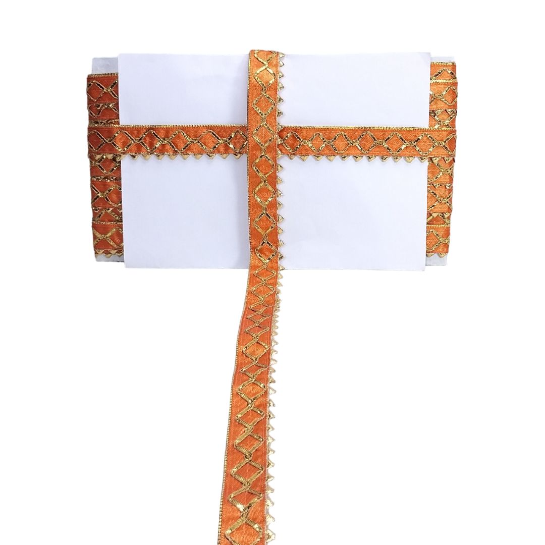 White garment with orange and gold embroidery on a white background