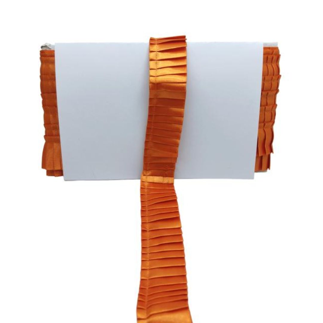 Orange pleated scarf on a white background