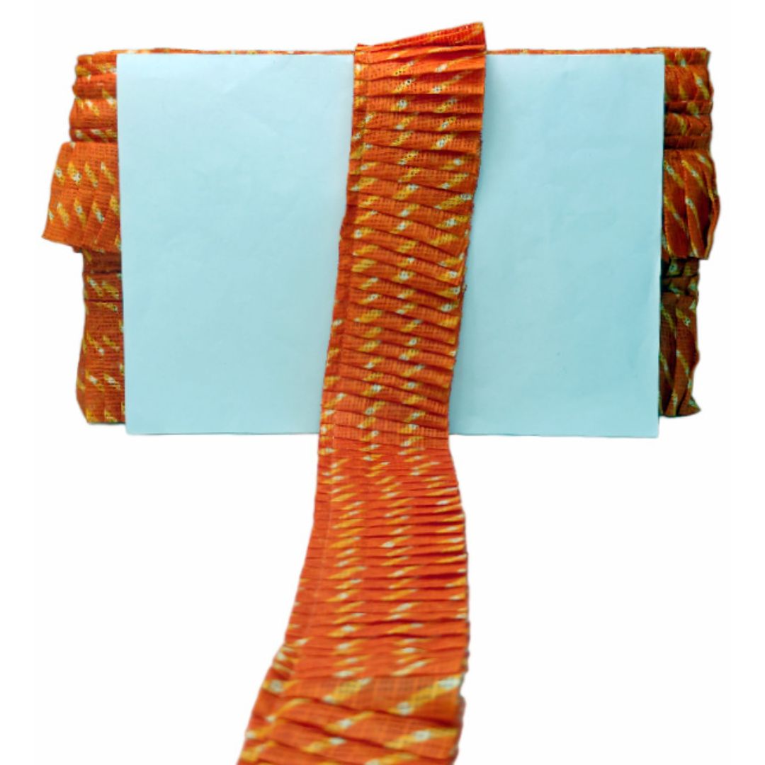Orange and white patterned fabric on a light blue background