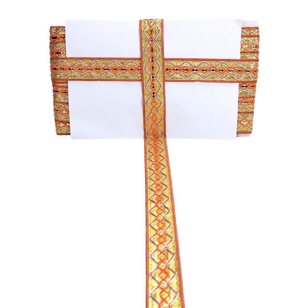 White garment with orange and green embroidered straps on a white background