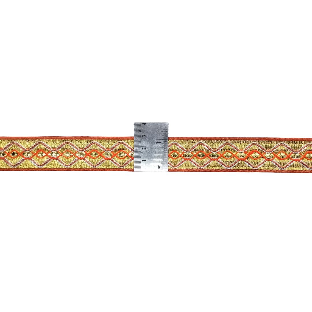 Decorative ribbon with geometric pattern and a ruler for scale on a white background