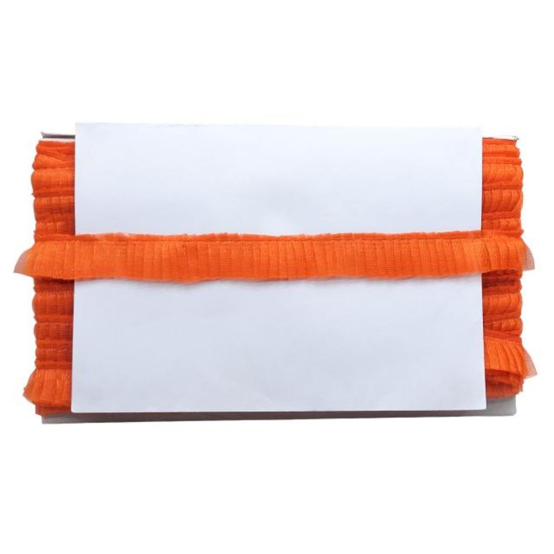 Orange ribbed fabric with a white card on a white background