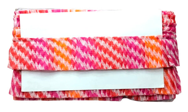 Folded fabric with pink and orange pattern on a white background