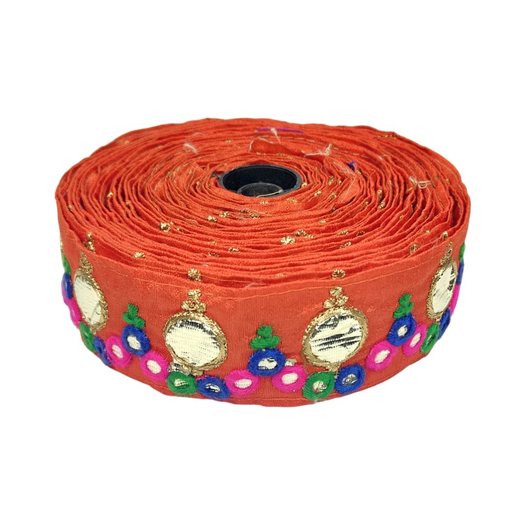 Roll of decorative ribbon with colorful patterns on a white background