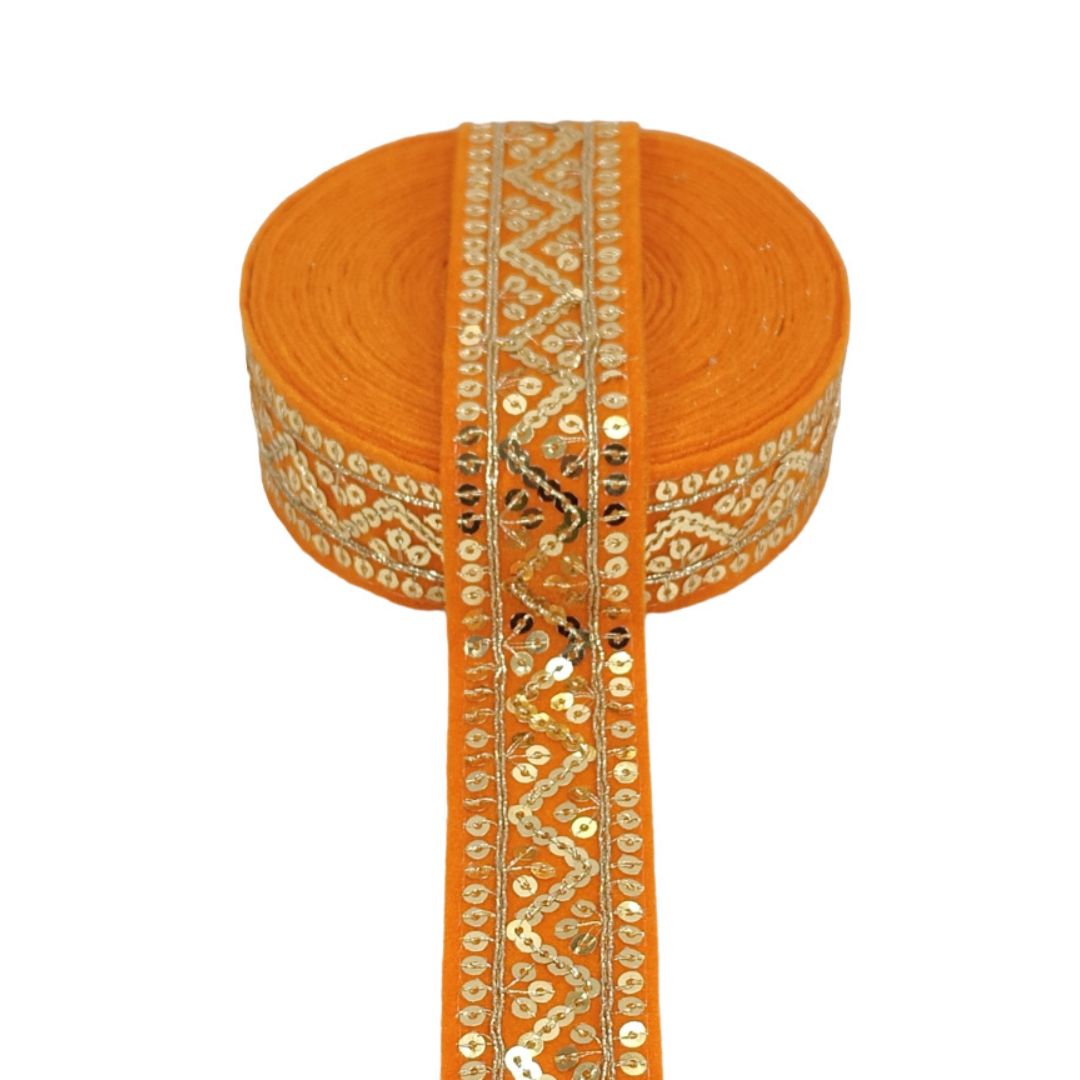 Orange ribbon with gold embroidery on a white background