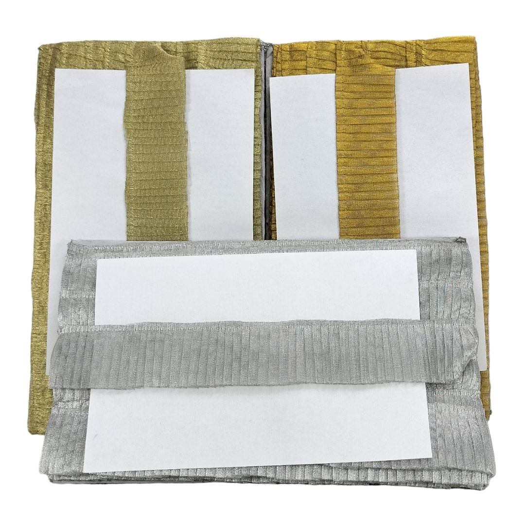 Folded fabric swatches in green, white, and gray on a white background