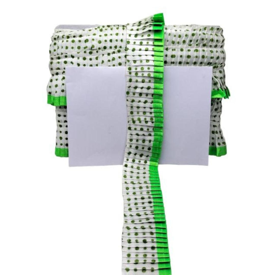 Green and white patterned fabric with a white card on a white background