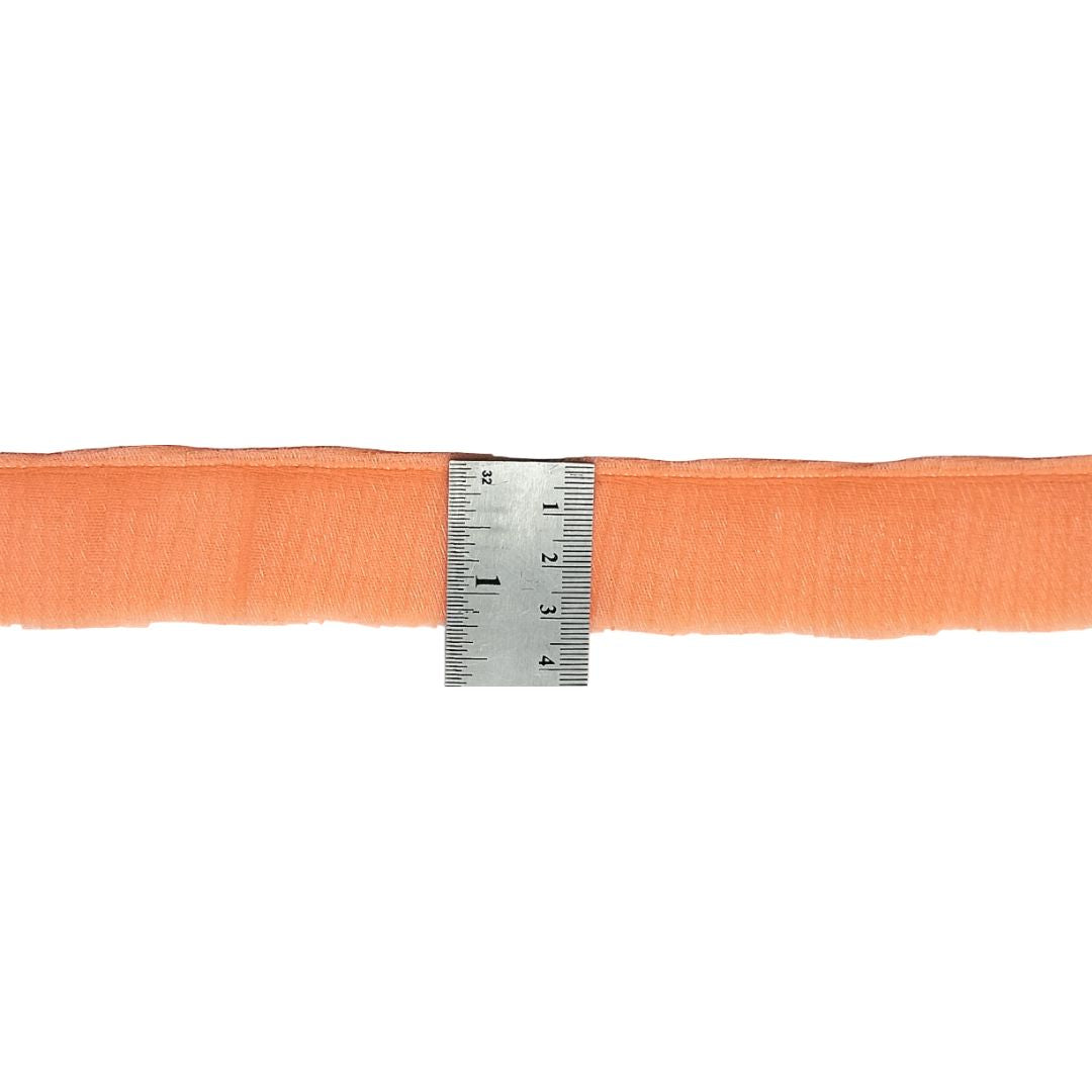Orange belt with a ruler for size reference on a white background