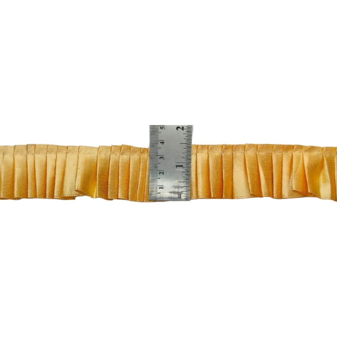 Measuring tape on a strip of yellow fabric with a white background