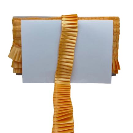 Decorative lamp with ruffled orange shade on a white background