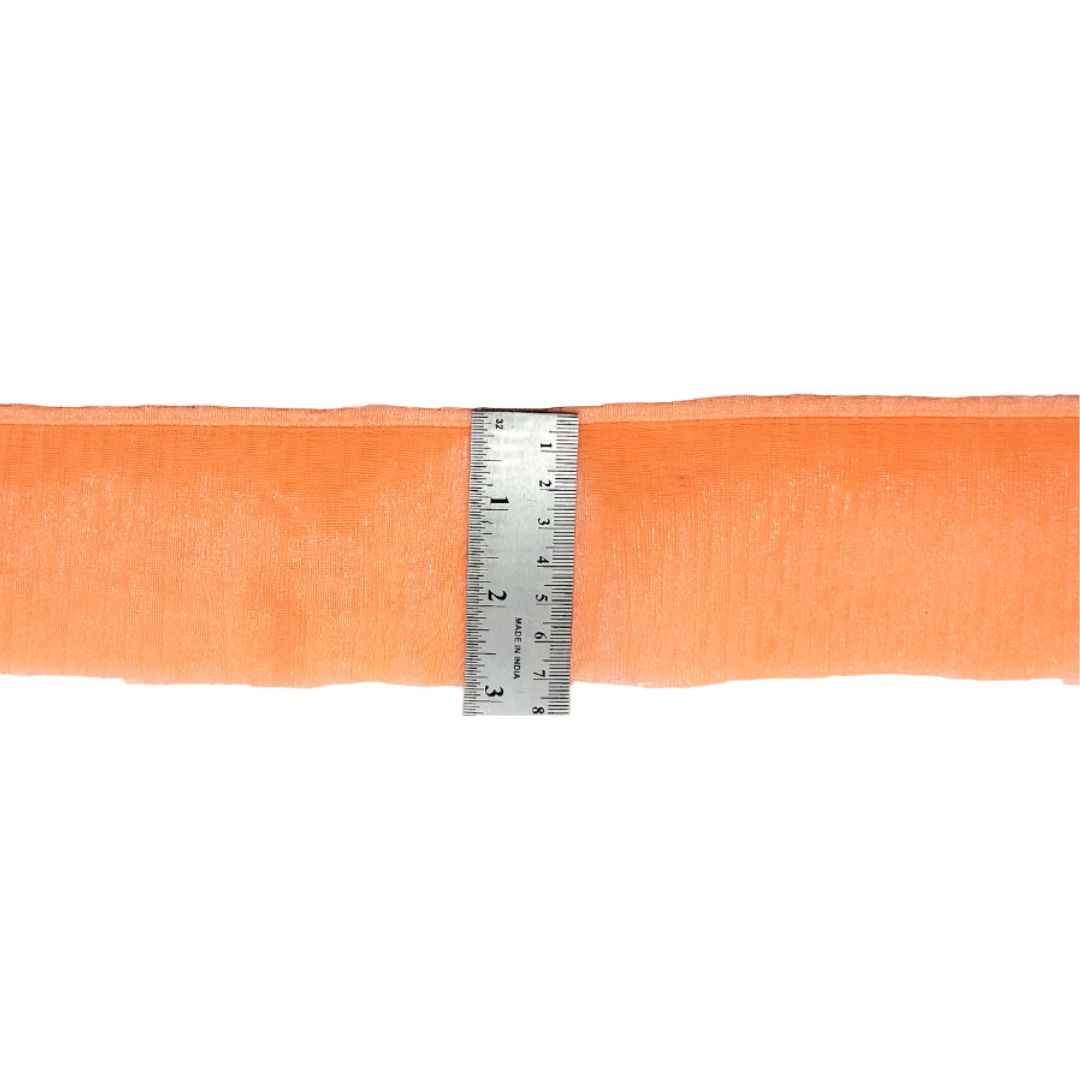 Orange mesh ribbon with a ruler for measurement on a white background