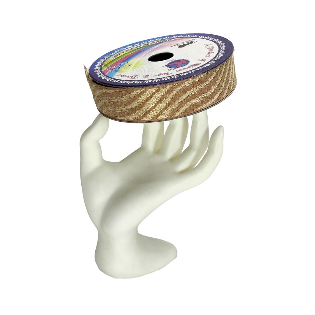 Spool of ribbon on a white mannequin hand with a white background