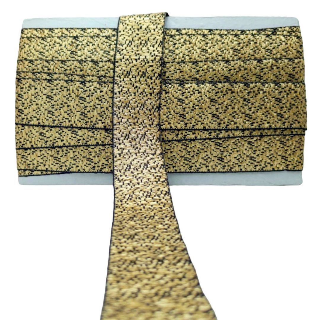 Gold and black patterned fabric with a white background