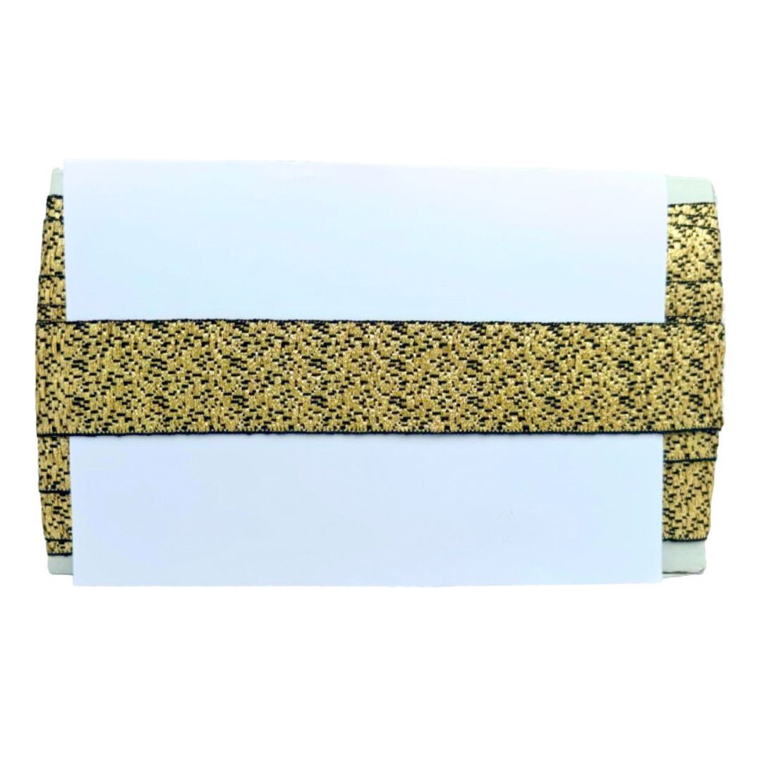 Clutch bag with gold and black pattern on a white background