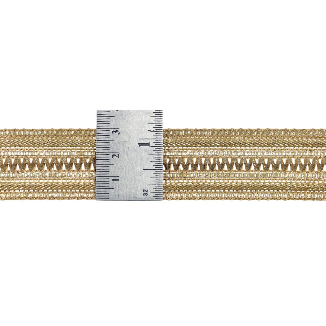Gold braided cord with a ruler for scale on a white background