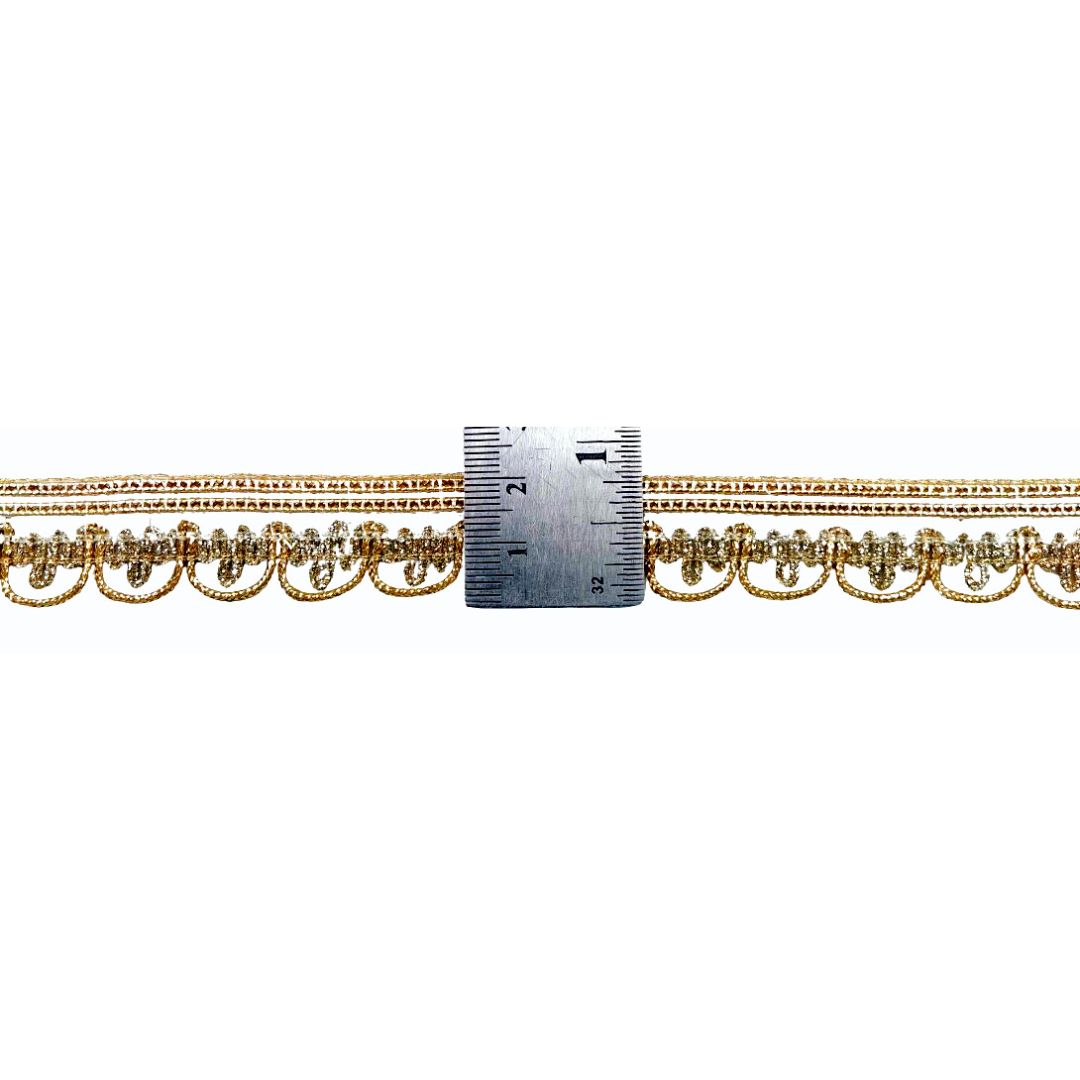 Gold chain with a ruler for scale on a white background