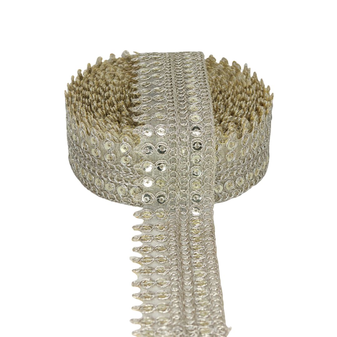 Decorative ribbon with gold and silver embellishments on a white background