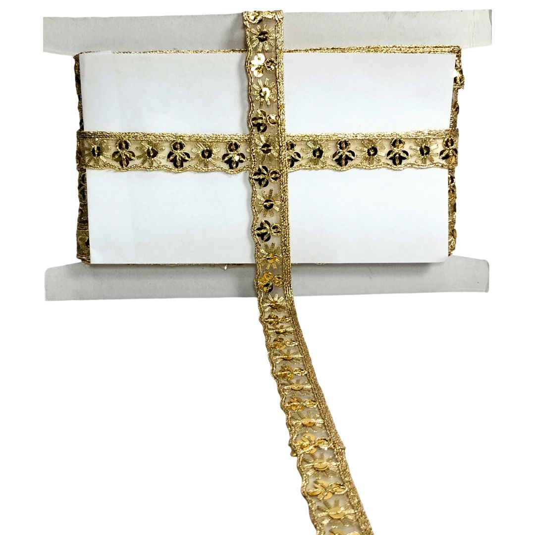 Decorative gold ribbon with intricate patterns on a white background