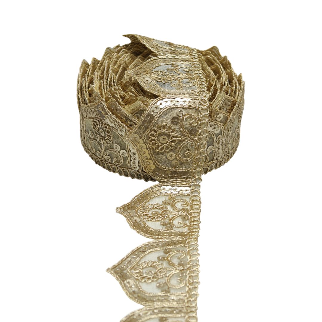 Decorative gold lace ribbon on a white background