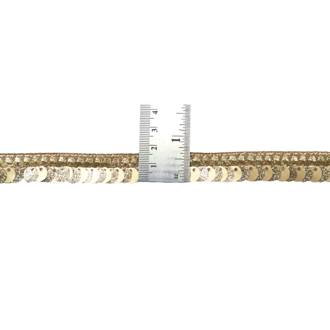 Gold and silver metallic ribbon with a ruler for measurement on a white background