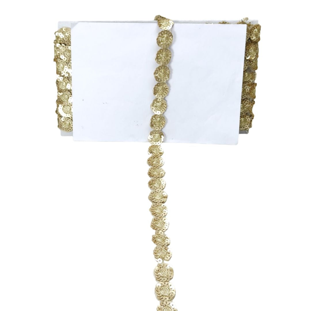 White napkin with gold decorative trim on a white background