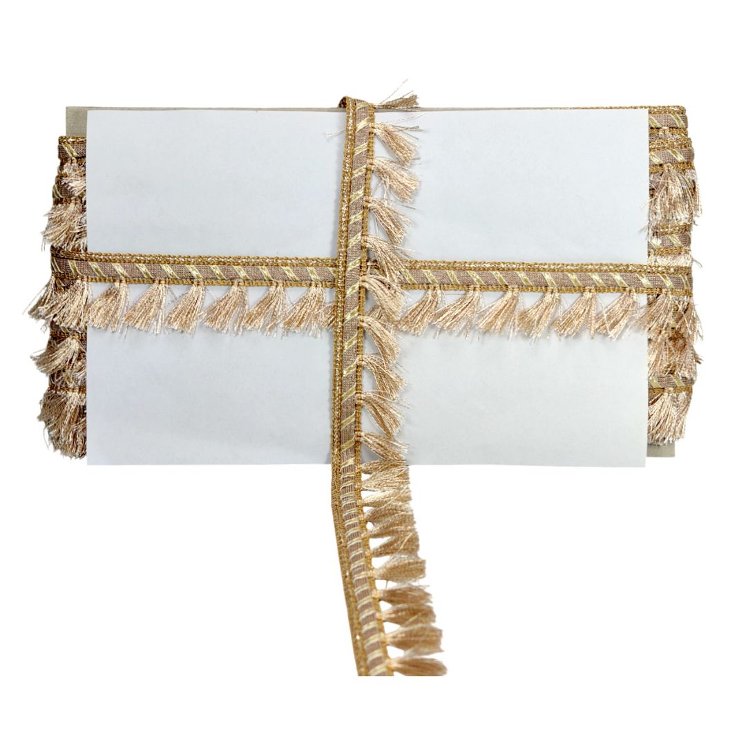 White clutch bag with gold fringe on a white background