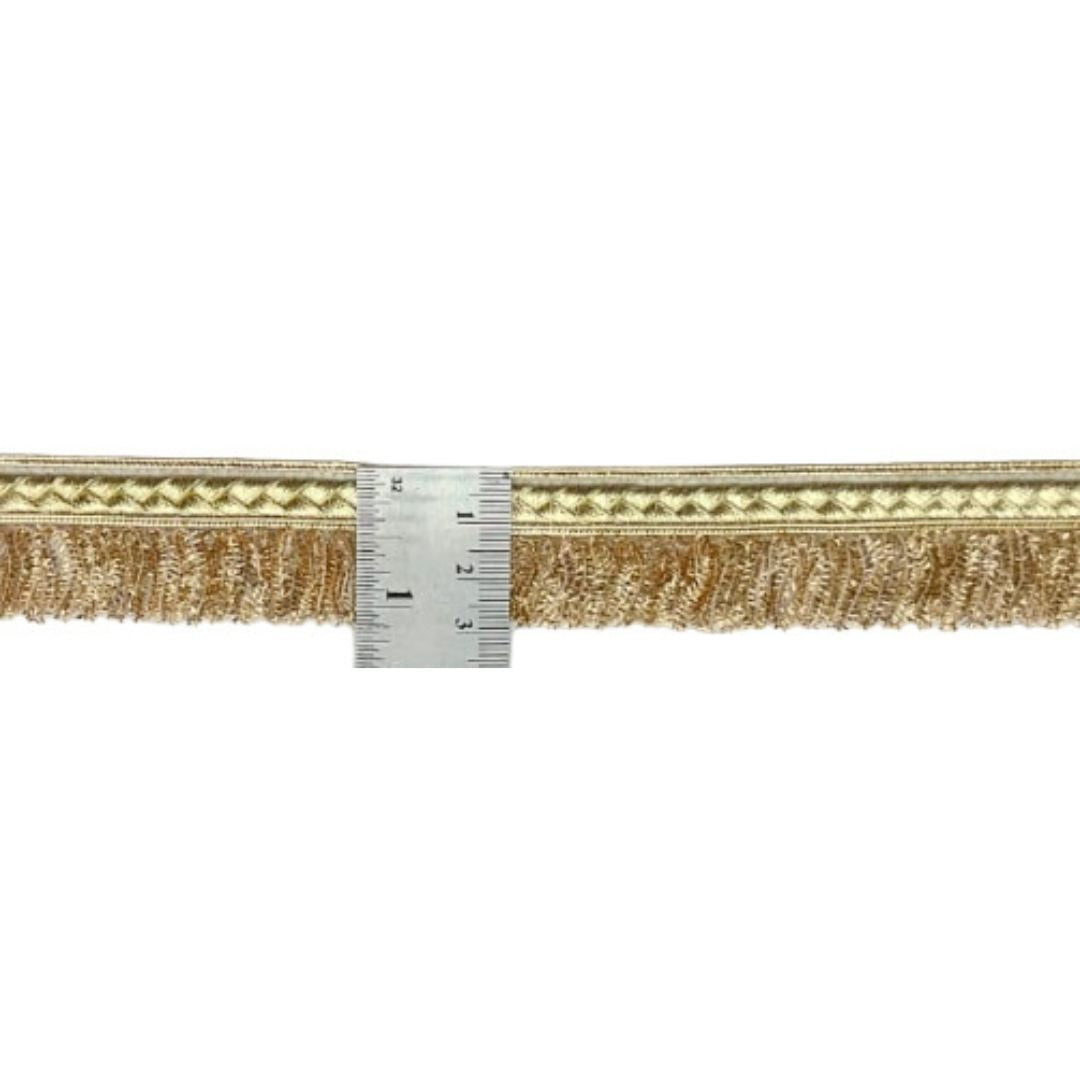 Gold decorative trim with a ruler for scale on a white background