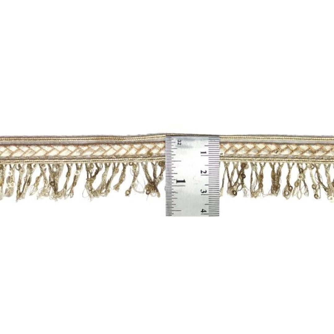 Decorative lace trim with a ruler for scale on a white background