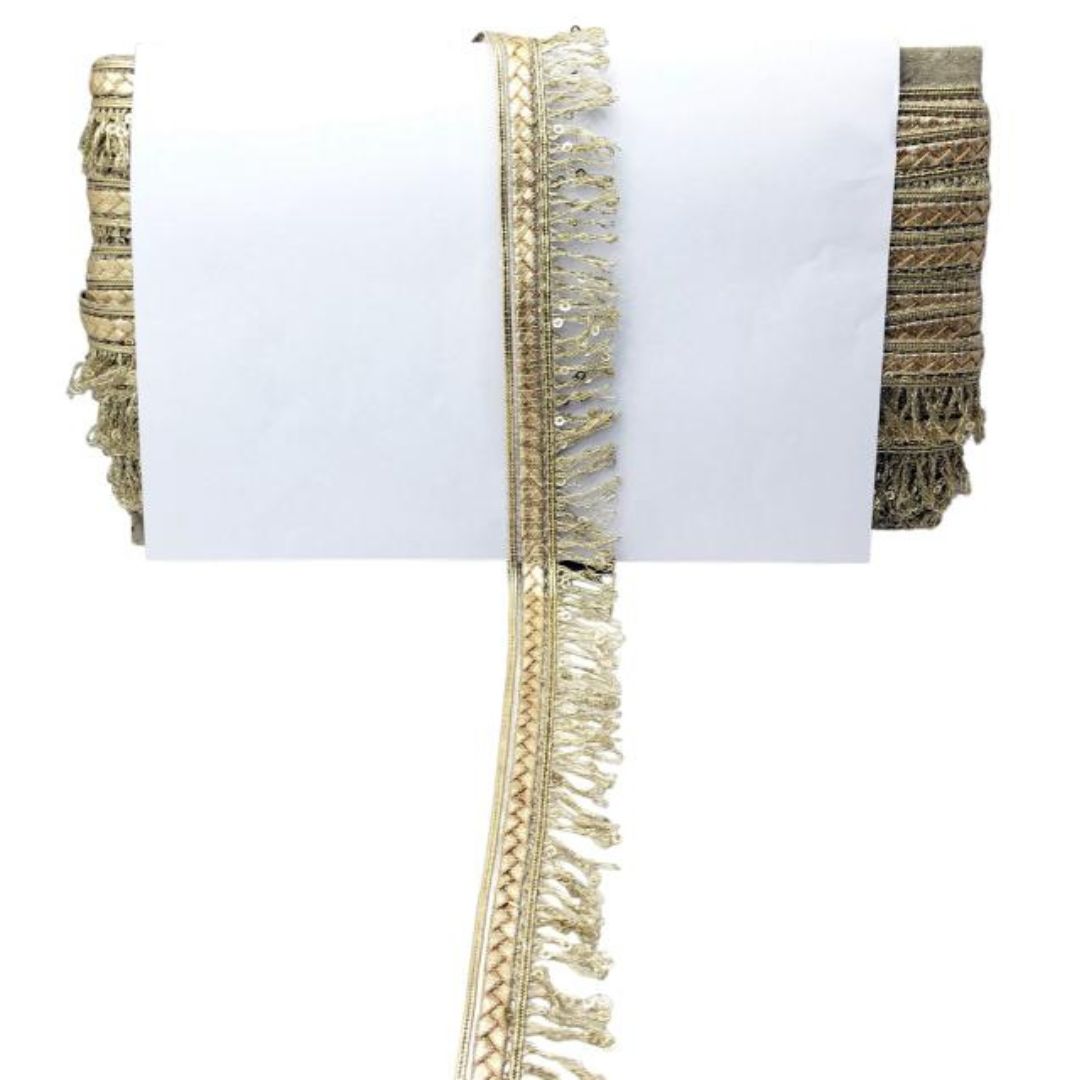Gold fringe trim on a white background