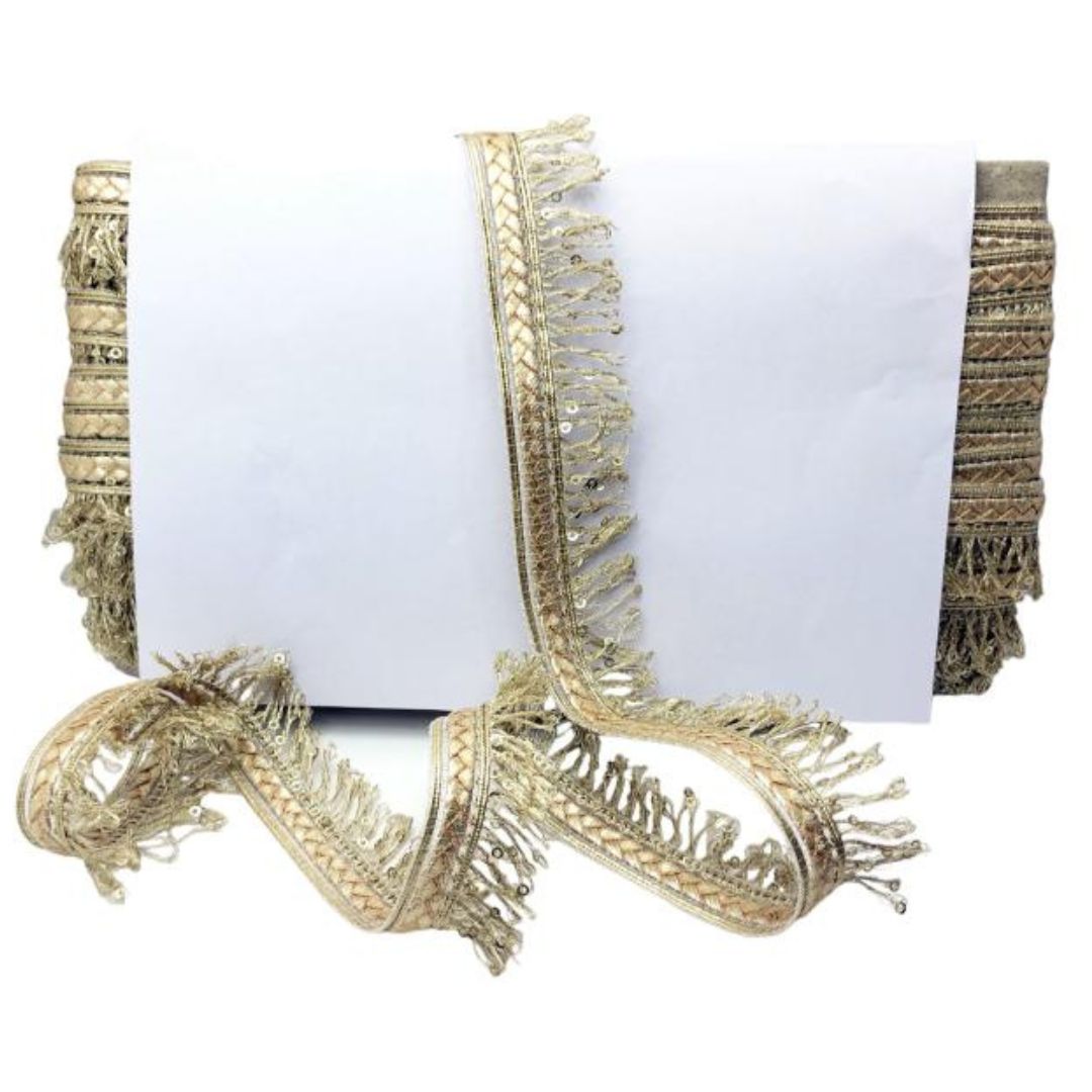 Decorative gold fringe trim on a white background