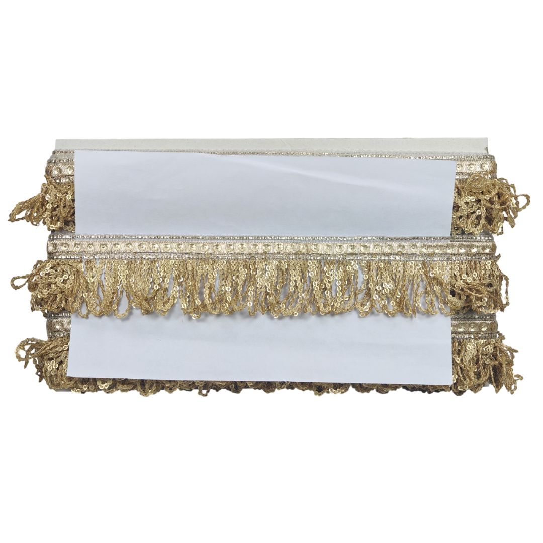 Gold clutch with fringe details on a white background