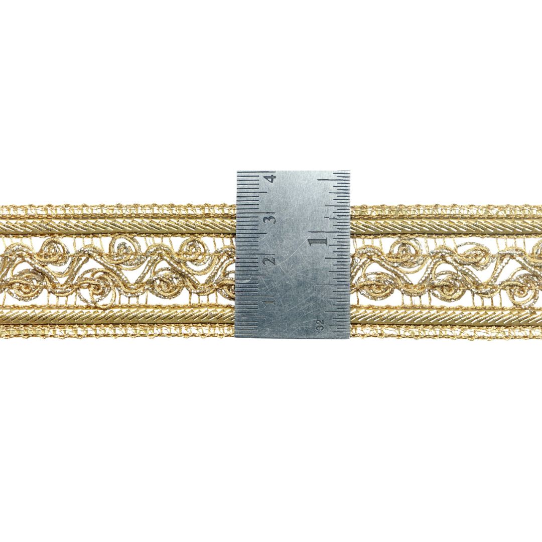 Gold decorative trim with a ruler for scale on a white background